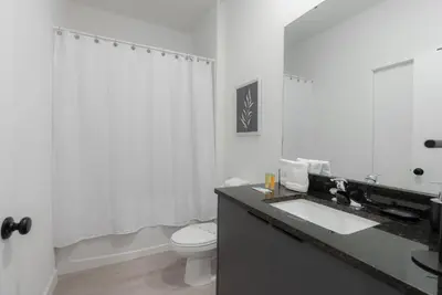 a white bathroom with a sink and a toilet at Amazing 03 Bedrooms 03 Baths Sleeps 08 in Kissimmee