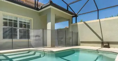 a swimming pool in front of a house at Amazing 05 Bedrooms 4 Bathrooms Sleeps 14 in Kissimmee