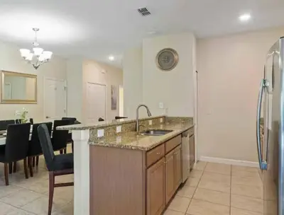 a large kitchen with a sink and a refrigerator at Amazing 05 Bedrooms 4 Bathrooms Sleeps 14 in Kissimmee