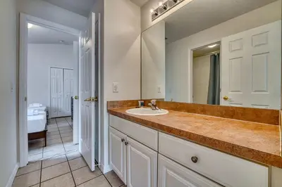 a bathroom with a sink and a mirror at Private Pool Getaway Near Theme Parks in Kissimmee