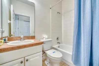 a bathroom with a toilet and a sink and a tub at Private Pool Getaway Near Theme Parks in Kissimmee