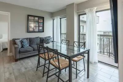 a dining room with a glass table and chairs at Amazing 2 Bedrooms Nex to Universal in Orlando