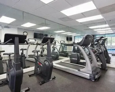 a gym with several treadmills and cardio machines at Amazing 2 Bedrooms Nex to Universal in Orlando