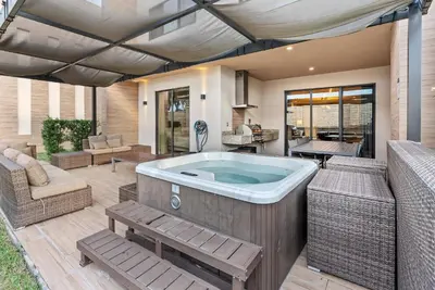 a jacuzzi tub on a patio at Home Luxury 4 BedsPrivate Hot Tub Close Disney in Orlando