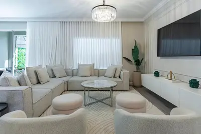 a living room with a couch and a table and chairs at Brand New 5 Bedrooms4 Baths At Storey Lake in Kissimmee