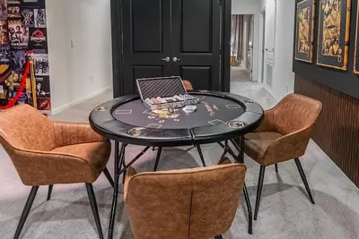 a table with a laptop on it with chairs at Brand NEW 12Bedrooms12Bathroom At Paradiso Grande in Orlando