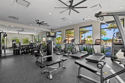 a gym with a lot of treadmills and machines at Brand NEW 12Bedrooms12Bathroom At Paradiso Grande in Orlando
