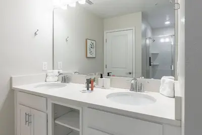 a bathroom with two sinks and a large mirror at NEW Cozy 2 Bedrooms2Baths At Storey Lake in Kissimmee