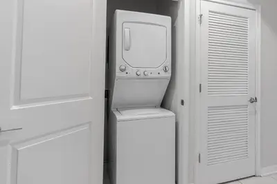 a television sitting in a room next to a door at NEW Cozy 2 Bedrooms2Baths At Storey Lake in Kissimmee
