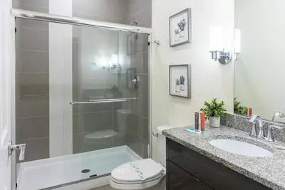 a bathroom with a shower and a toilet and a sink at Amazing 3 Bedrooms with Private Pool- Close to Disney in Orlando