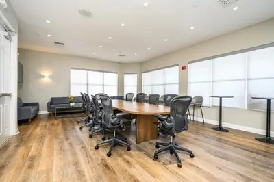 a conference room with a wooden table and chairs at Epic Universe New Listing Beautiful Vacation Condo - 3018 in Orlando
