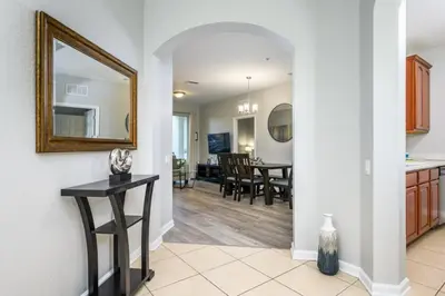 a kitchen and living room with a mirror and a table at Epic Universe New Listing Beautiful Vacation Condo - 3018 in Orlando