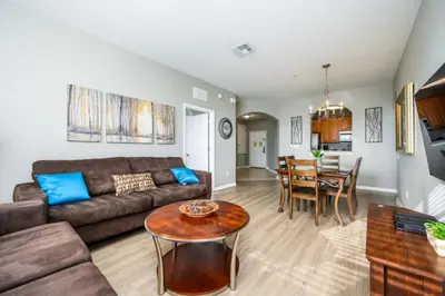 a living room with a couch and a table at Epic Universe Beautiful Lakeview Condo, Vista Cay Orlando - 3013 in Orlando
