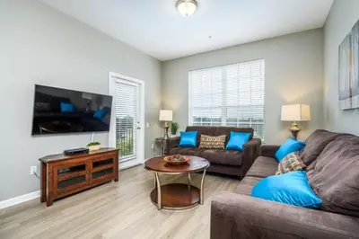a living room with a couch and a tv at Epic Universe Beautiful Lakeview Condo, Vista Cay Orlando - 3013 in Orlando