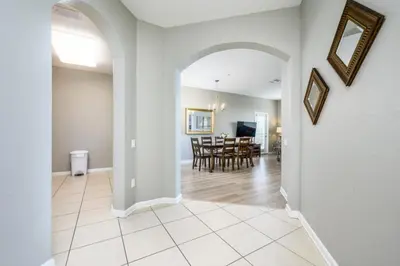 a living room with an archway and a dining room at Epic Universe Beautiful Lakeview Condo, Vista Cay Orlando - 3013 in Orlando