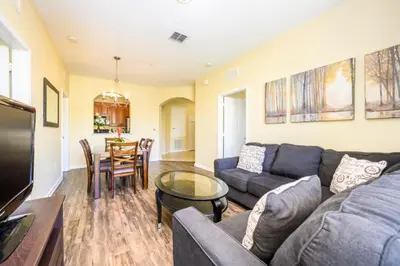a living room with a couch and a table at Beautiful Deluxe Condo, Vista Cay - 3015 in Orlando