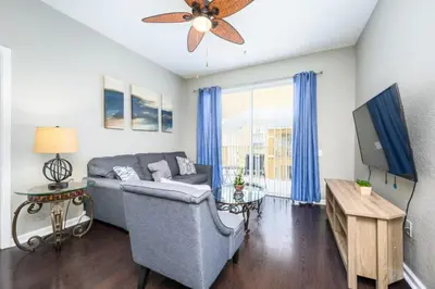 a living room with a couch and a ceiling fan at Beautiful Deluxe Condo, Vista Cay - 3024 in Orlando