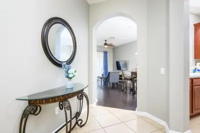 a mirror on a wall above a table in a kitchen at Beautiful Deluxe Condo, Vista Cay - 3024 in Orlando