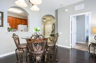 a kitchen and dining room with a table and chairs at Beautiful Deluxe Condo, Vista Cay - 3024 in Orlando