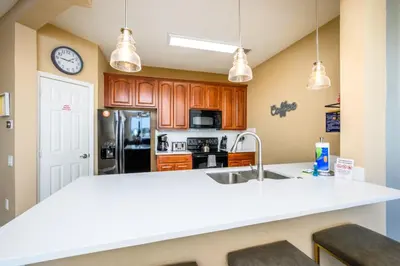 a kitchen with a white counter top and a sink at Beautiful Modern Condo, Near the Parks! - 3021 in Orlando