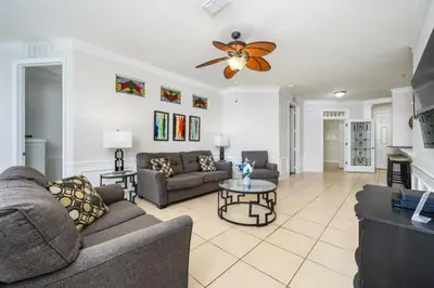 a living room with a couch and a table at Epic Universe 4 Bedroom Plus, Lake View Condo, Vista Cay-1008 in Orlando