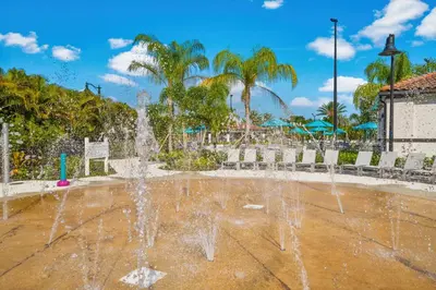 a fountain in a park with palm trees at Epic Universe Penthouse Vacation Condo, Near the Parks - 2014 in Orlando