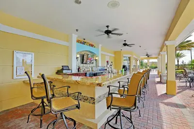 a bar in a restaurant with chairs around it at Epic Universe New Listing! Lakeview Condo, Vista Cay - 1017 in Orlando