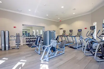 a gym with several treadmills and cardio machines at Beautiful Deluxe Condo, Vista Cay - 3023 in Orlando