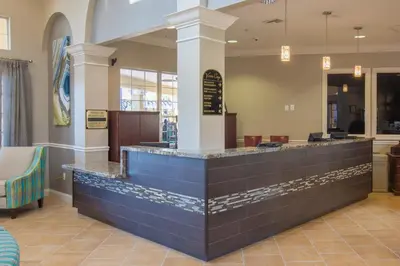 a restaurant with a blue counter in a lobby at Beautiful Deluxe Condo, Vista Cay - 3023 in Orlando