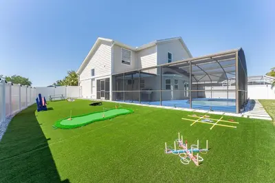 a house with a large yard with a lawnitures at Villa Resort Club in Kissimmee