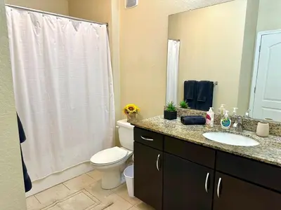 a bathroom with a white toilet and a sink at Orlando Bliss Near Disney in Orlando