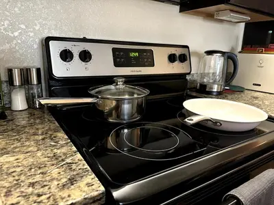 a stove top with two pots and a bowl on it at Orlando Bliss Near Disney in Orlando
