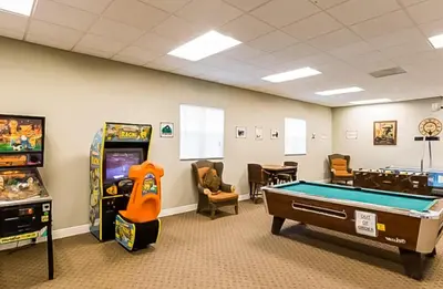 a room with a pool table and arcade games at Oakwater Fountain View 3BR Home, Pool, By Disney in Orlando