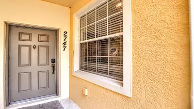 a door of a house with a window at Oakwater Fountain View 3BR Home, Pool, By Disney in Orlando