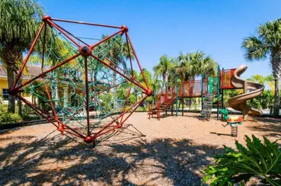 a playground with a slide in a park at Oakwater Fountain View 3BR Home, Pool, By Disney in Orlando