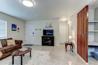 a living room with a couch and a tv at Downtown Duplex B Private Yard Great Location in Sanford