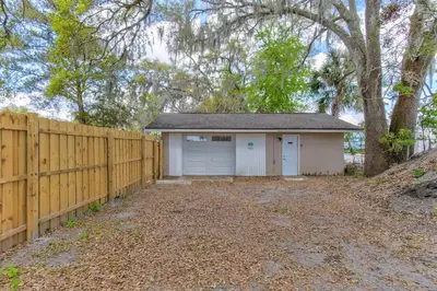 a home with a fence and a garage at Happy Palette Home Close to downtown Fenced yard in Sanford
