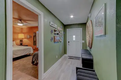 a room with green walls and a bedroom with a bed at Happy Palette Home Close to downtown Fenced yard in Sanford