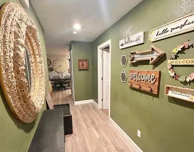 a hallway with a room with a wall with signs on it at Happy Palette Home Close to downtown Fenced yard in Sanford