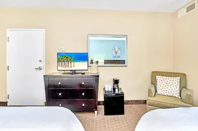 a hotel room with a bed and a chair at Studio near Universal Studios w Games & BBQ in Orlando