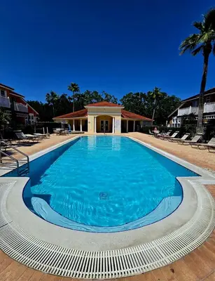 a large blue swimming pool in front of a building at Casa Maria- A piece of Heaven in Kissimmee