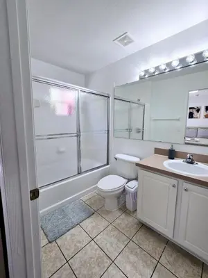 a bathroom with a shower and a toilet and a sink at Casa Maria- A piece of Heaven in Kissimmee