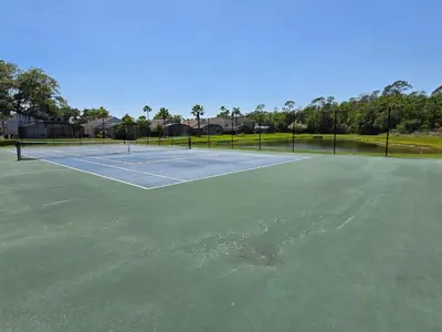 a tennis court with a ball on it at Casa Maria- A piece of Heaven in Kissimmee