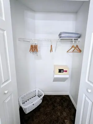 a white closet with a shelf and a basket at Casa Maria- A piece of Heaven in Kissimmee