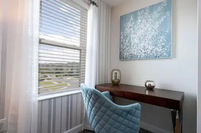 a room with a desk and a chair and a window at Villa 6Q Disney Style c/ Piscina e Game Room in Kissimmee