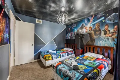 two beds in a room with a star wars mural at Disney-Area Kissimmee 3BR | Community Pool in Kissimmee