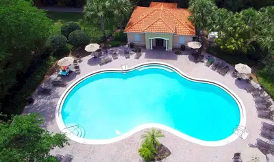 an overhead view of a swimming pool at a resort at Grand Panoramic 3BR Townhouse Near Disney Parks in Kissimmee