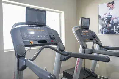 a treadmill with a laptop on top of it at Near Universal Parks Cozy Apartament at The Point in Orlando