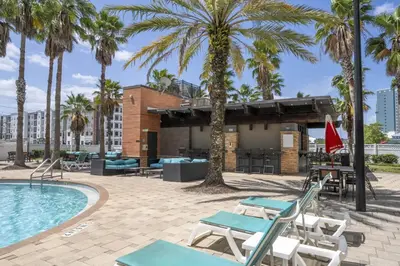 a resort with a pool and palm trees at Near Universal Parks Cozy Apartament at The Point in Orlando