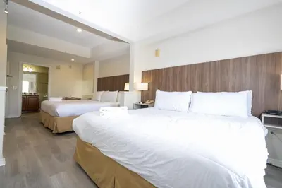 a hotel room with two beds and a bathroom at Near Universal Parks Cozy Apartament at The Point in Orlando